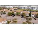 Beautiful aerial view of townhomes with parking, lush landscaping, and a pond at 3185 Pequod Pl, Kissimmee, FL 34746