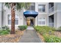 Inviting condo entrance with covered awning, pathway, landscaping, and building number clearly displayed at 3301 Whitestone Cir # 204, Kissimmee, FL 34741