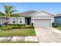 Inviting single-Gathering home featuring a well-maintained lawn and a two-car garage at 3493 Lazy River Ter, Sanford, FL 32771