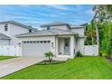 Charming home featuring a grey roof, white exterior, two car garage and beautiful lawn at 350 E 2Nd Ave, New Smyrna Beach, FL 32169