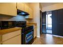 Cozy kitchen featuring an electric stove, wooden countertops, and tile flooring at 385 Eron Way # 45, Winter Garden, FL 34787