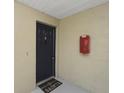 Close-up of unit entrance door with a welcome mat and visible house number at 4300 Hector Ct # 7, Orlando, FL 32822