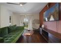 Comfortable living room with modern decor, sleek entertainment center, and plush green sofa at 4300 Hector Ct # 7, Orlando, FL 32822