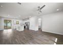 Spacious open-concept living area featuring wood floors, ceiling fan and lots of natural light at 4470 Frances Ave, Sanford, FL 32773