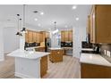 Bright kitchen with stainless steel appliances, island, quartz countertops, and elegant hexagon tile backsplash at 674 Whisper Woods Dr, Lakeland, FL 33813