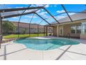 Screened-in pool features a spacious patio and tranquil views at 674 Whisper Woods Dr, Lakeland, FL 33813