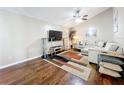 Comfortable living room featuring hardwood floors, a ceiling fan, and a large sectional sofa at 7565 Dockside St, Winter Park, FL 32792