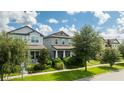 Charming two-story home with well-manicured lawn and healthy, mature trees at 7853 Summerlake Groves St, Winter Garden, FL 34787