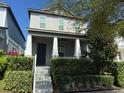 Charming two-story home with a welcoming front porch and well-maintained landscaping at 7853 Summerlake Groves St, Winter Garden, FL 34787