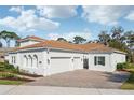 Lovely single-story home featuring a terracotta roof, large garage, and paved driveway at 8064 Peaceful Cir, Sanford, FL 32771