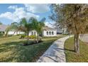 Charming home with lush landscaping, mature trees, and a terracotta tile roof at 8064 Peaceful Cir, Sanford, FL 32771