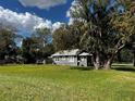 View of a cozy single-Gathering house with a satellite dish and lush green lawn at 914 2Nd St, Orlando, FL 32824