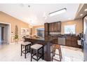 Modern eat-in kitchen with an island, stainless steel appliances, and white marble floors at 1012 E De Carlo Dr, Deltona, FL 32725