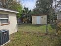 Fenced backyard featuring a lawn and a storage shed with decorative accents at 1130 E Bay St, Winter Garden, FL 34787