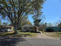 Charming single-story house featuring a carport and mature trees in a residential area at 1130 E Bay St, Winter Garden, FL 34787