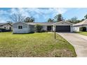 Attractive single-story home with manicured lawn, gray paint, and inviting curb appeal at 1183 Feather Dr, Deltona, FL 32725