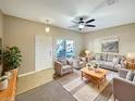 Cozy living room featuring neutral tones, comfortable seating, and a ceiling fan at 1260 Honey Blossom Dr, Orlando, FL 32824