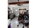 Cozy living room with vaulted ceiling, complete with tile floor and a ceiling fan at 131 San Blas Ave, Kissimmee, FL 34743