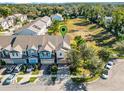 Aerial view of townhome with a well-maintained lawn and proximity to green space at 1335 E 10Th St, Apopka, FL 32703