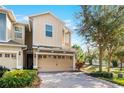 Inviting two-story townhouse with a two-car garage and meticulously landscaped front yard at 1335 E 10Th St, Apopka, FL 32703