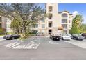 Apartment building with lush landscaping, exterior stone accents, and ample parking at 1371 Tuscan Terrace # 3203, Davenport, FL 33896