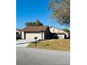 Exterior shot of a well-maintained single Gathering home with a two-car garage and mailbox at 1422 Spalding Rd, Winter Springs, FL 32708