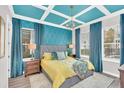 Stylish bedroom with teal ceiling, walls and curtains, and a queen bed at 1427 Fairview Cir, Reunion, FL 34747