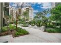 Exterior courtyard view with seating, lush greenery, and elegant landscaping at 14501 Grove Resort Ave # 2522, Winter Garden, FL 34787