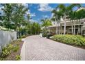 Brick driveway with manicured landscaping, and an inviting entrance at 14501 Grove Resort Ave # 2522, Winter Garden, FL 34787