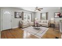 Bright living room with hardwood floors, a ceiling fan and stylish furniture; perfect for relaxing and entertaining at 1975 Staunton Ave, Winter Park, FL 32789