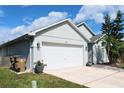 Exterior view of the home showcasing the garage and landscaping at 2511 Crown Ridge Cir, Kissimmee, FL 34744