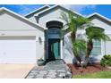 Close-up of front entrance with stone pathway and meticulously landscaped yard at 2511 Crown Ridge Cir, Kissimmee, FL 34744