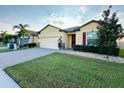 Well maintained single-story home with brick paved driveway and manicured lawn at 2706 Vermillion Ct, St Cloud, FL 34771