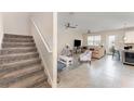 Bright living room with neutral tile flooring and a staircase to the upper level at 2929 Satire St, Kissimmee, FL 34746