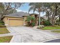 Spacious driveway and attached two-car garage of a well-maintained home surrounded by trees at 2958 Willow Bay Ter, Casselberry, FL 32707