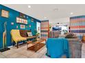 Bright and stylish living room with tile floors, blue accent wall, and eclectic decor at 30 Cornwall Ct, Casselberry, FL 32707