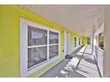 Bright hallway featuring white columns, sunny yellow walls and a glimpse of the blue skies at 3162 Sun Lake Ct # B, Kissimmee, FL 34747