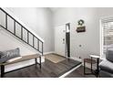 Open entryway with dark floors, coat rack, and a staircase leading to the second story at 509 Shane Cir, Winter Springs, FL 32708