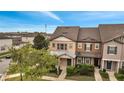 Well-maintained townhome with neutral paint scheme, complementing the manicured landscaping at 5095 Caspian St, St Cloud, FL 34771