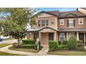 Well-maintained two-story townhome with a cozy front porch and manicured shrubs at 5095 Caspian St, St Cloud, FL 34771