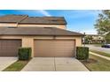 Attached two-car garage featuring concrete driveway and manicured landscaping at 5095 Caspian St, St Cloud, FL 34771