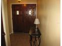 Inviting foyer featuring a double wooden door, decorative lamp and neutral walls at 5121 Hoperita St, Orlando, FL 32812