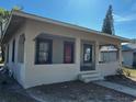 Inviting single-story home with covered porch, red door, and well-maintained exterior at 542 N 8Th St, Eagle Lake, FL 33839