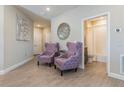 Inviting foyer with stylish chairs and decor leading to the bathroom at 7517 Laureate Blvd # 4103, Orlando, FL 32827