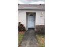 Front door with storm door and house number in a well-maintained neighborhood at 7706 Country Pl # 7706, Winter Park, FL 32792