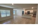 Open-concept kitchen with granite counters, white cabinets, stainless appliances, and tile flooring at 956 Brooklet Dr, Davenport, FL 33837