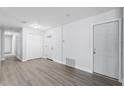 Spacious entryway featuring a closet, white doors, neutral paint, and wood flooring at 1117 N Hart Blvd, Orlando, FL 32818
