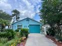 Charming blue home with a well-manicured front yard and inviting curb appeal at 11213 River Grove Dr, Orlando, FL 32817