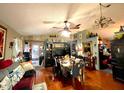 Open-concept living room and dining area with hardwood floors and natural light at 11213 River Grove Dr, Orlando, FL 32817