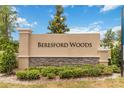 Beresford Woods community sign surrounded by lush landscaping against a beautiful blue sky at 1129 Blue Garden Dr, Deland, FL 32720